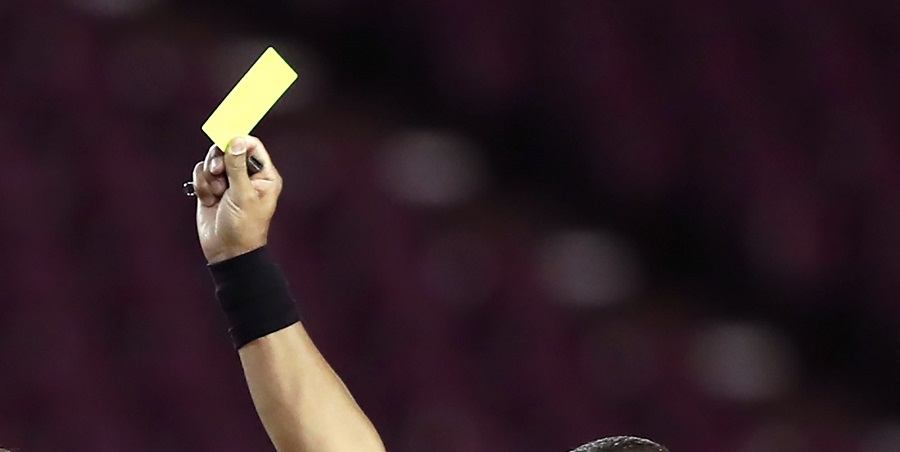 LANUS, ARGENTINA - JANUARY 13: Referee Wilton Sampaio shows a yellow card to Lautaro Acosta of Lanus during a semifinal second leg match between Lanus and Velez as part of Copa CONMEBOL Sudamericana 2020 at Estadio Ciudad de Lanus (La Fortaleza) on January 13, 2021 in Lanus, Argentina. (Photo by Agustín Marcarian - Pool/Getty Images)